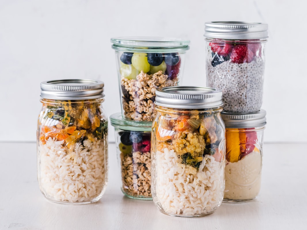 Woman preparing healthy meal with fresh vegetables and whole grains